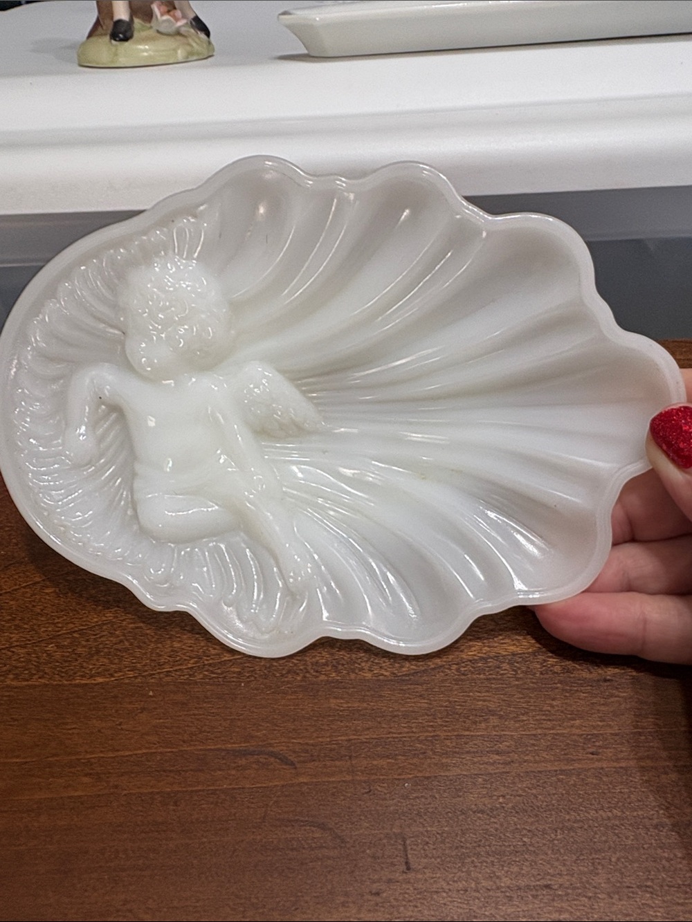 Avon milk glass cherub and seashell dish from the 1960s.